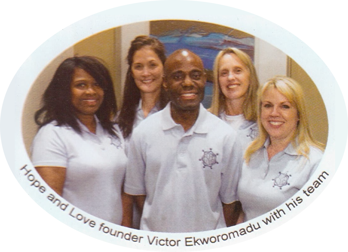 A group of people standing in front of a green background.